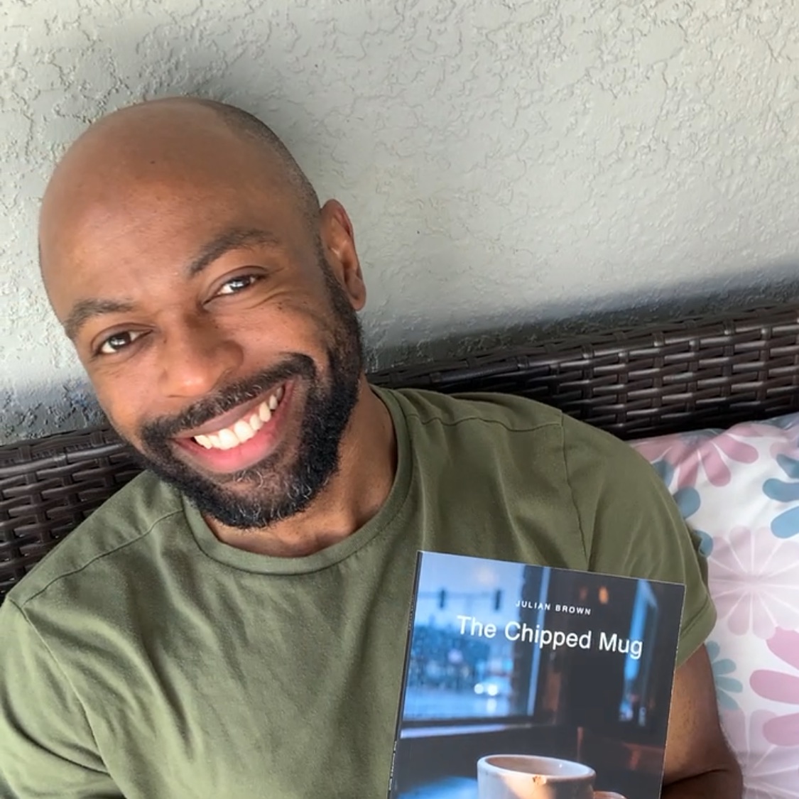 Julian Brown smiling and holding The Chipped Mug
